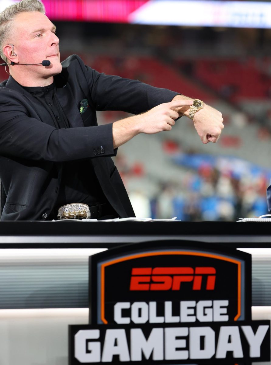 Pat McAfee flexes his Rolex to fans before the Fiesta Bowl in State Farm Stadium in Glendale, Ariz. on Jan. 8.