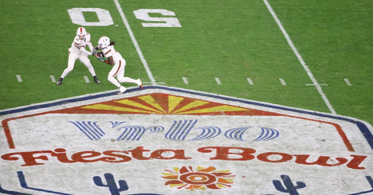 Carson Beck hands off the ball against Ole Miss in the Fiesta Bowl in State Farm Stadium in Glendale, Ariz. on Jan. 8.