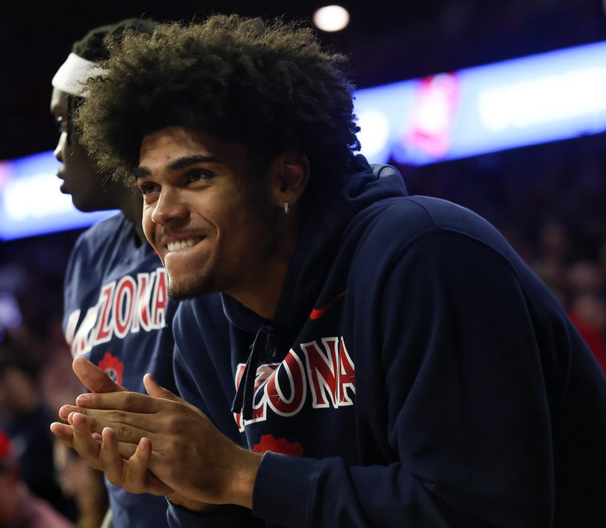 Koa Peat cheers on from the bench against BYU in McKale Center at ALKEME Arena on Feb. 18. Peat was sidelined due to a muscle strain.
