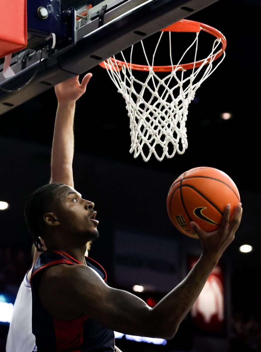 Jaden Bradley lays the ball up against BYU in McKale Center at ALKEME Arena on Feb. 18.