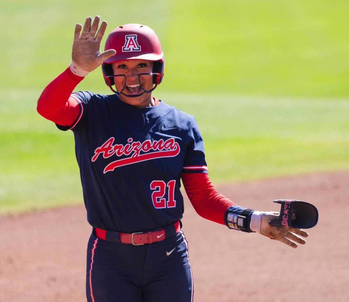 Sydney Stewart waves against No. 3 Oklahoma at Rita Hillenbrand Memorial Stadium on Feb. 8.