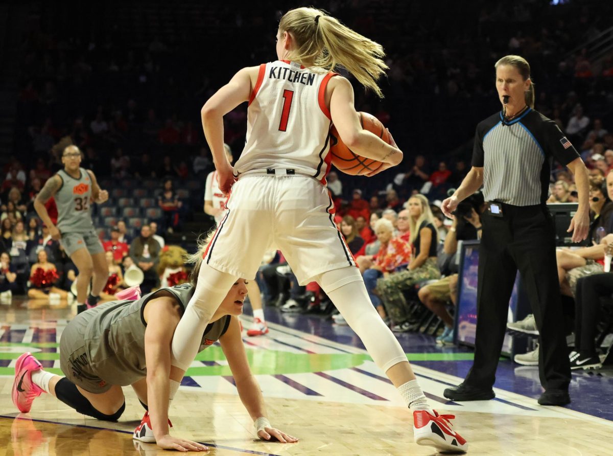 After catching a runaway ball, Kamryn Kitchen (1) stands her ground as an Oklahoma State University player lands on her leg in McKale Center on Feb 1, 2026.