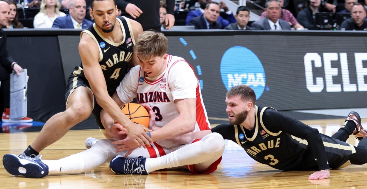 Motiejus Krivas (3) wrestles the ball away from two Purdue defenders during the Elite Eight round of March Madness in SAP Center on March 28 in San Jose.