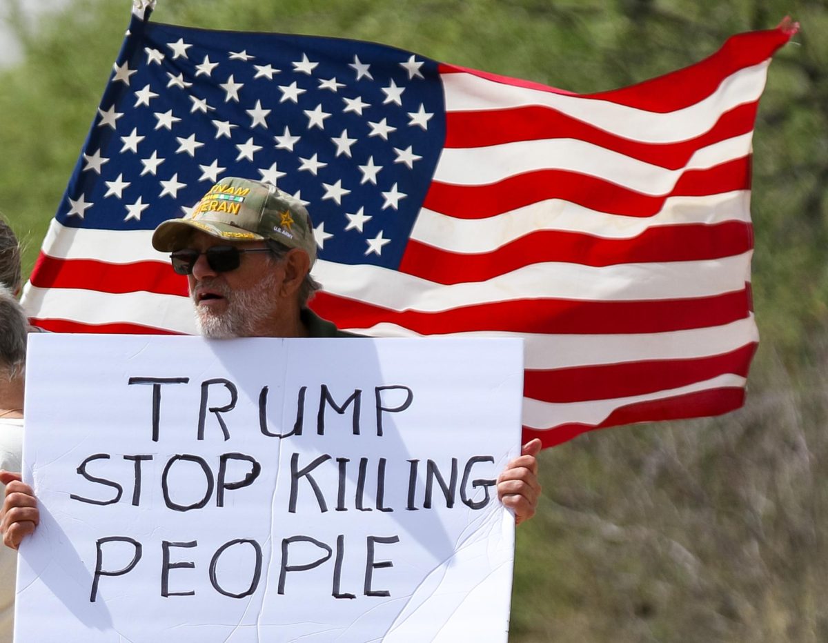 A protestor holds a sign in support of ‘No Kings Day’ on Kinney Road at Tucson Estates on March 28.