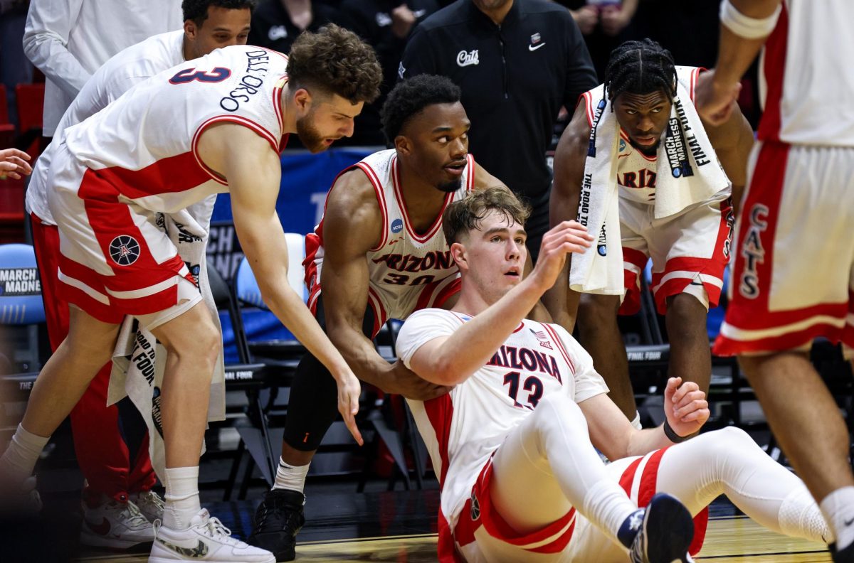 Motiejus Krivas is lifted up by teammates following a foul against Utah State in Viejas Arena in San Diego on March 22.