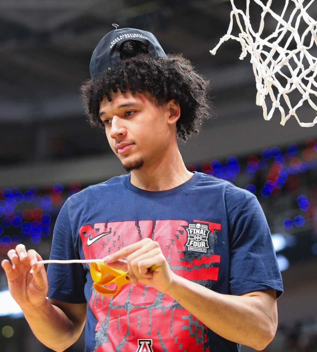 Brayden Burries cuts down the net after advancing to the Final Four with a win over Purdue in the Elite Eight on March 28 in SAP Center.