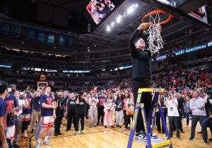 Tommy Lloyd cuts down the net as Arizona advances to the Final Four with a victory against Purdue University on March 28 in SAP Center.