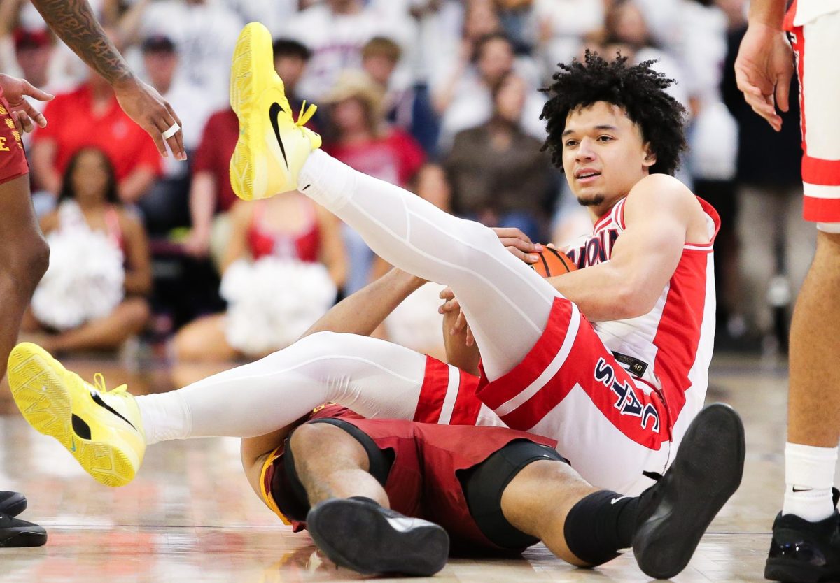 Brayden Burries fights with an Iowa State player for the ball in McKale Center on Mar. 2.