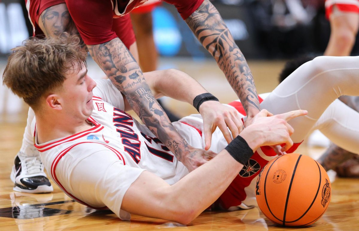 Motiejus Krivas fights on the hardwood for the ball during Arizona's Sweet Sixteen matchup against Arkansas on march 26 in SAP Center in San Jose.
