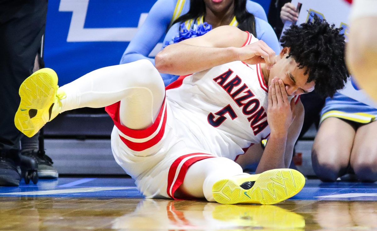 Brayden Burries falls to the floor following contact with a Long Island player in Viejas Arena in San Diego on March 20.