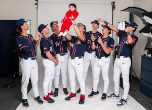 Chaz Mcnelis holds up his son, Grayson McNelis, during a baseball media day.