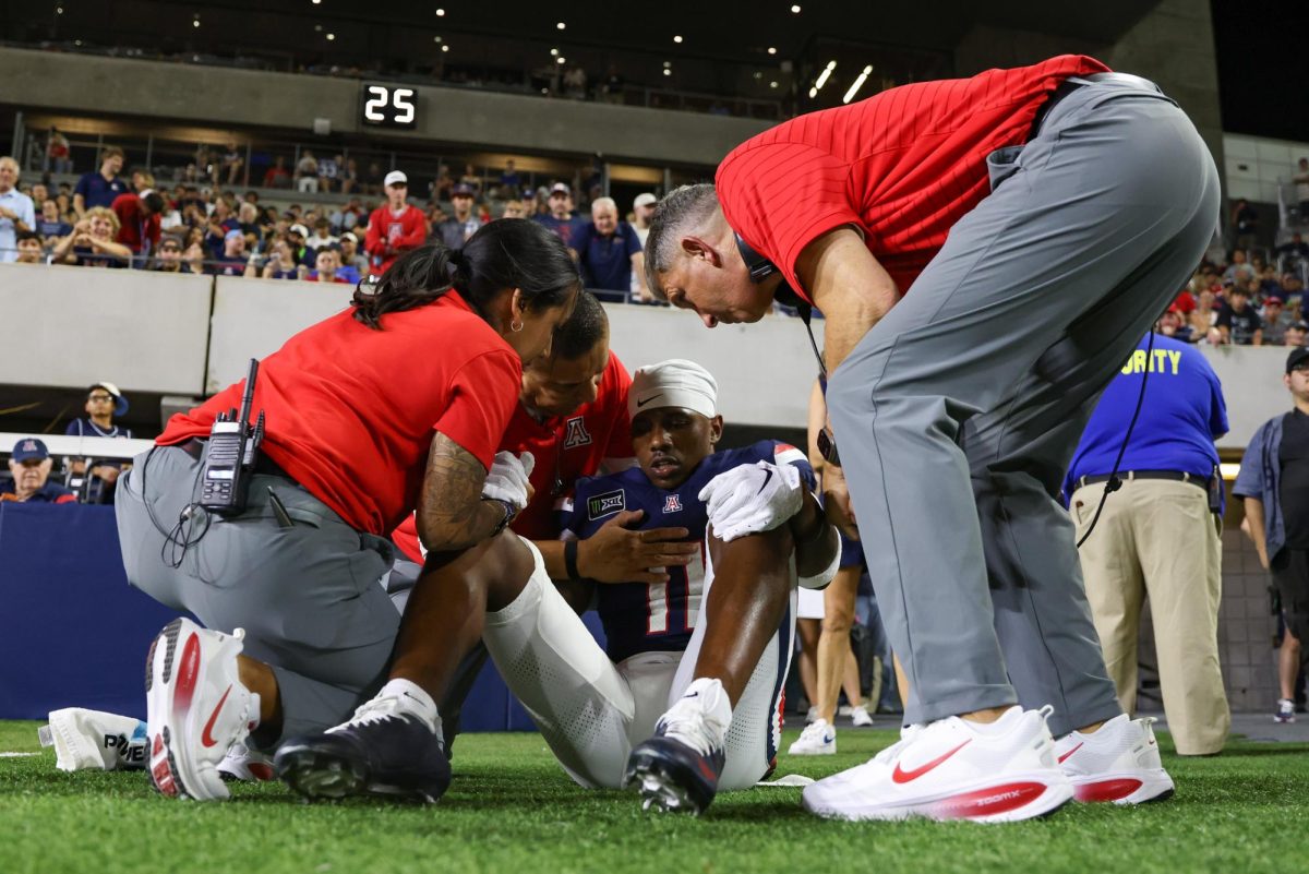 Arizona athletic training staff and Head Coach Brent Brennan check on Chris Hunter III after a hard landing in the endzone against NAU on Casino Del Sol Stadium on Sept. 5.