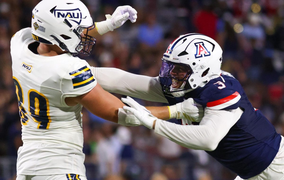 Tre Smith rushes a NAU defender  at Casino Del Sol Stadium on Sept. 5.