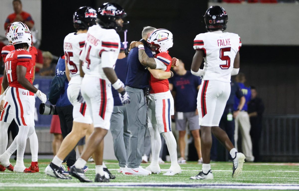 Brent Brennan congratulates Noah Fifita after breaking the all time passing yards record at Arizona on Sept. 19 at Casino Del Sol Stadium.