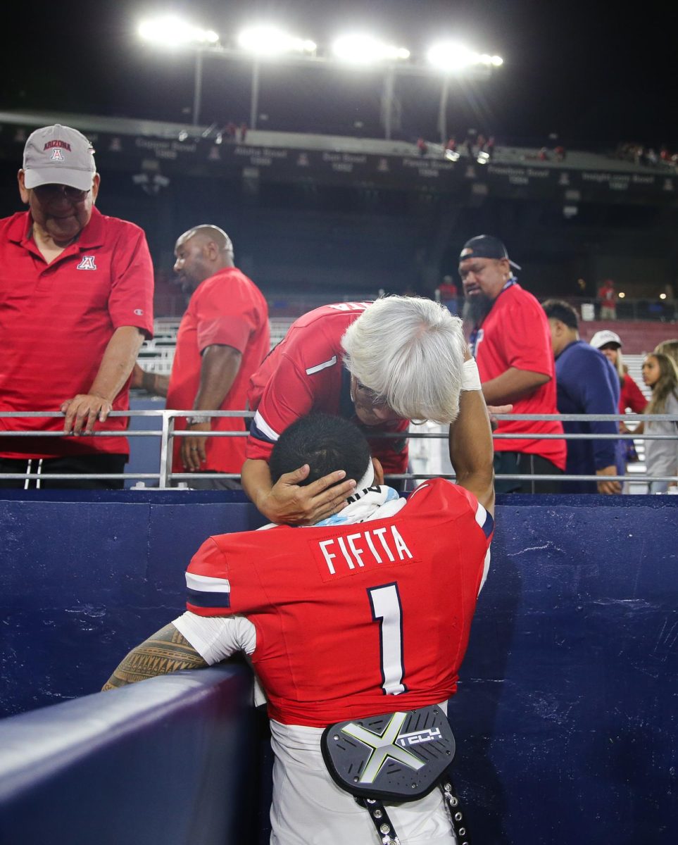 Noah Fifita talks with his family after Arizona's win against NIU on Sept. 19 at Casino Del Sol Stadium.
