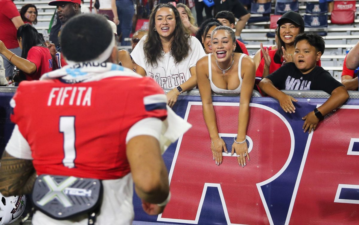 Noah Fifita runs to his fiancee after Arizona's win over NIU on Sept. 19 at Casino Del Sol Stadium.
