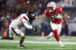 Quincy Craig stiff arms a defender against NIU on Sept. 19 at Casino Del Sol Stadium.