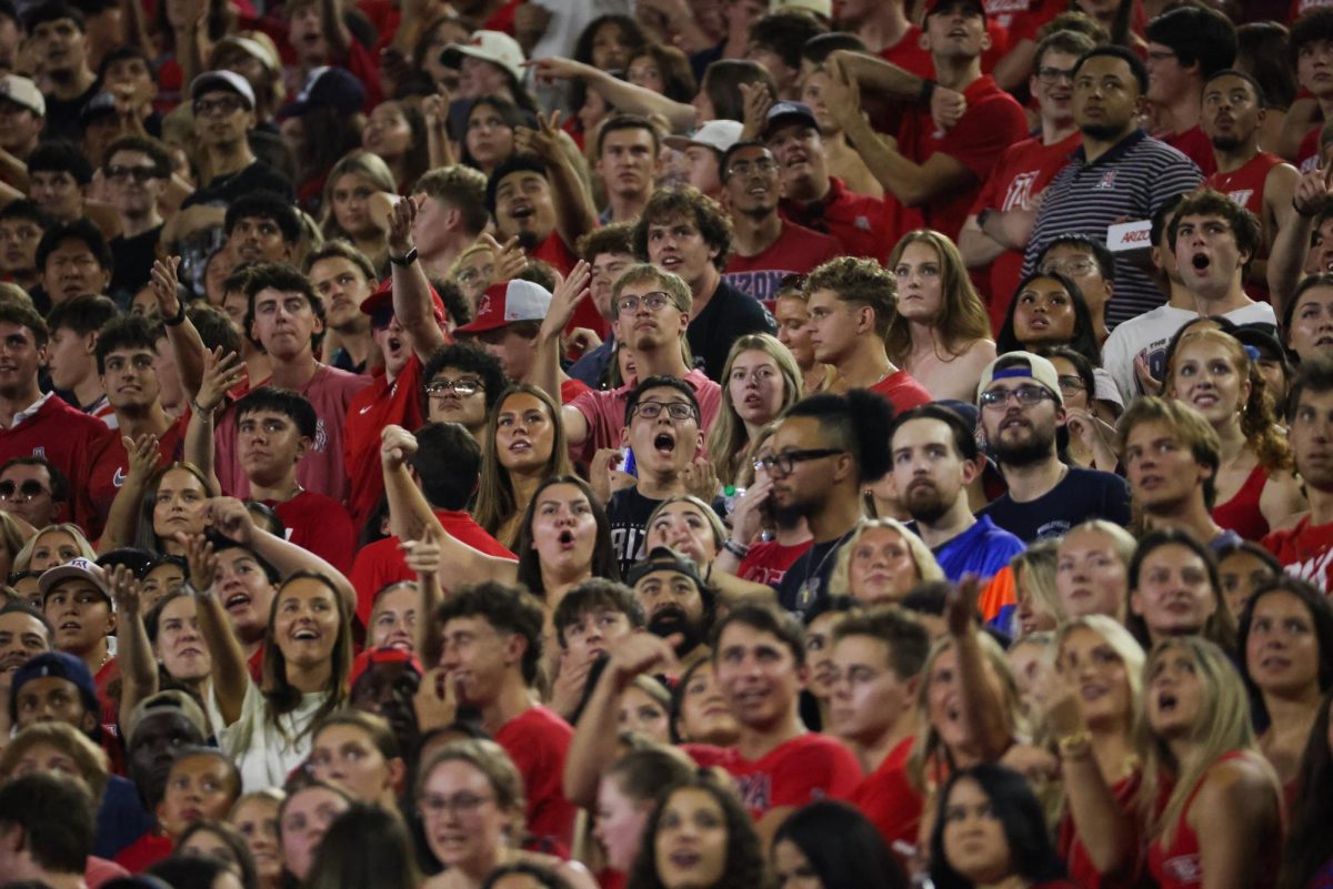 Fans look on at the video board during a video review against NIU on Sept. 19 at Casino Del Sol Stadium.