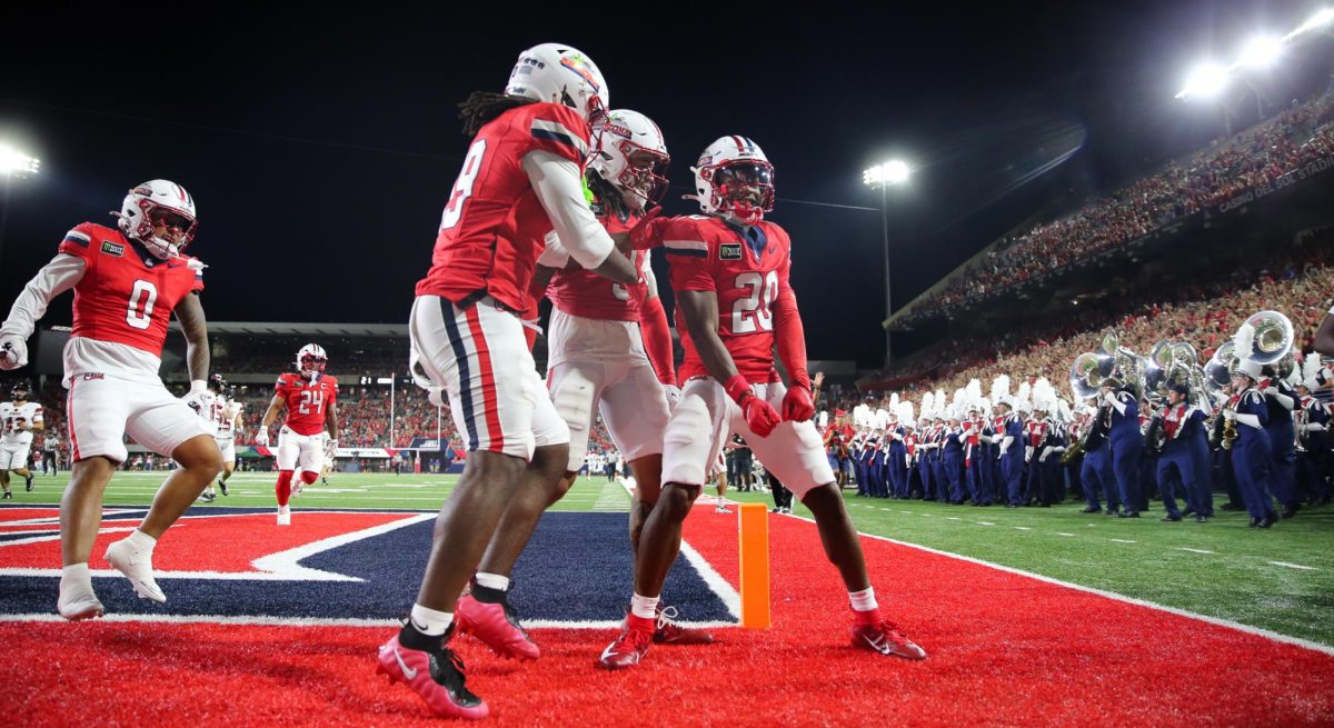 Caleb Smith celebrates his 69 yard punt return touchdown against NIU on Sept. 19 at Casino Del Sol Stadium.