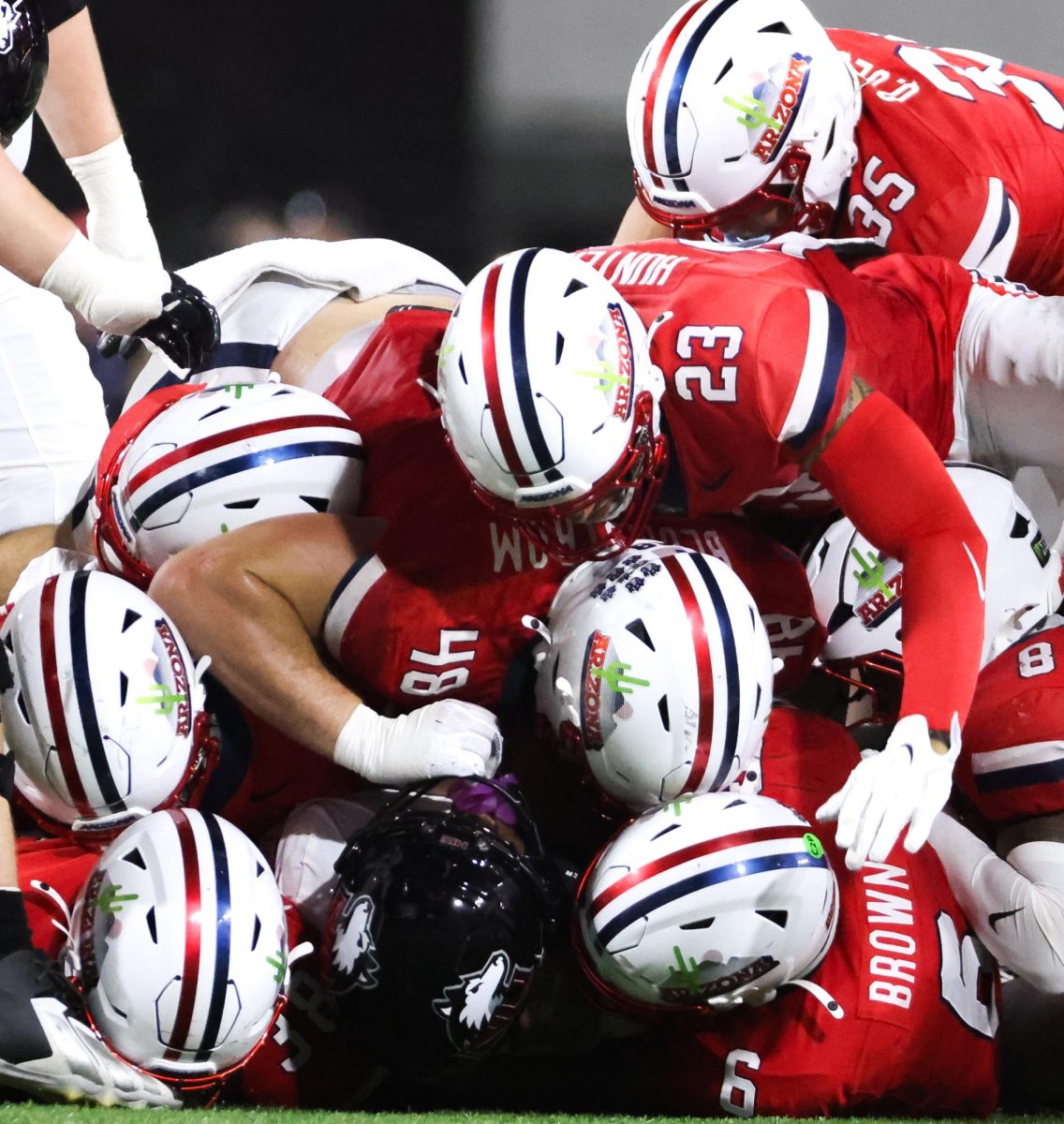 Arizona dogpiles onto the ballcarrier against NIU on Sept. 19 at Casino Del Sol Stadium.