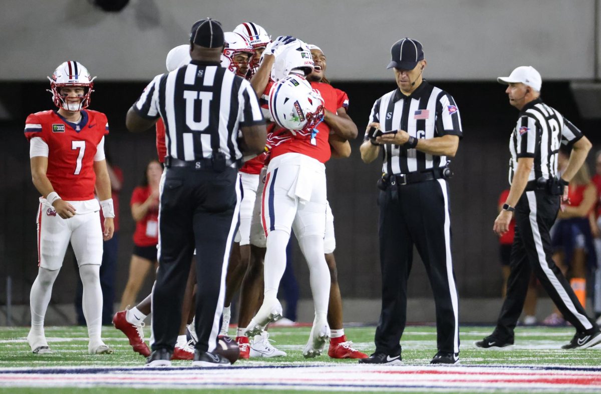 Noah Fifita gets congratulated after breaking the all time passing yards record against NIU on Sept. 19 at Casino Del Sol Stadium.