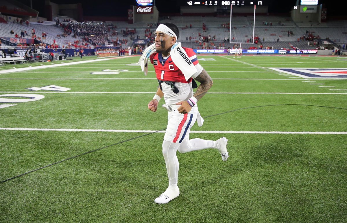 Noah Fifita jogs off the field after breaking the all time passing yards record in Arizona's win over NIU on Sept. 19 at Casino Del Stadium.