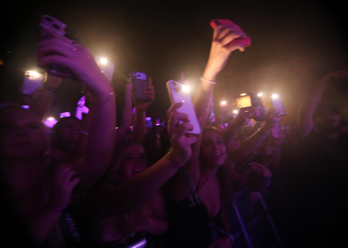 Fans film the Offset concert on their phones on Sept. 24.