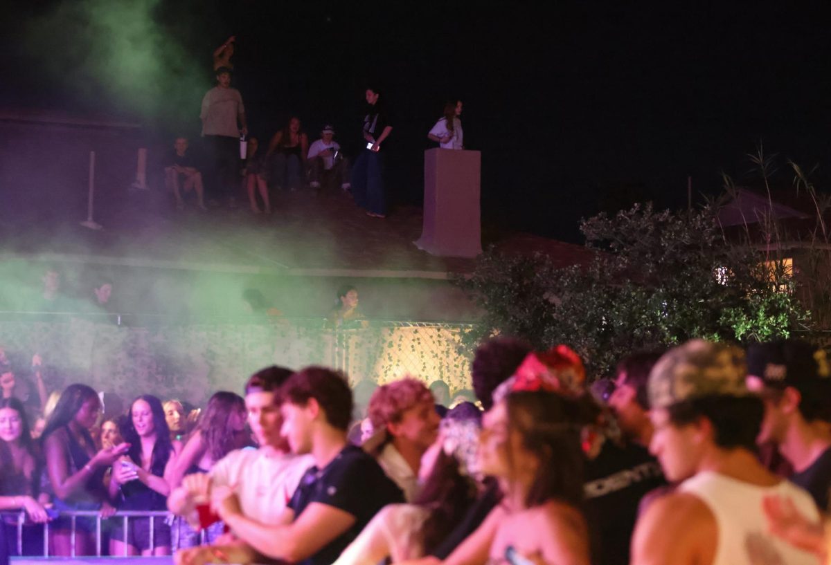 Students from next door sit on their roof to watch the Offset concert at ZBT on Sept. 24.