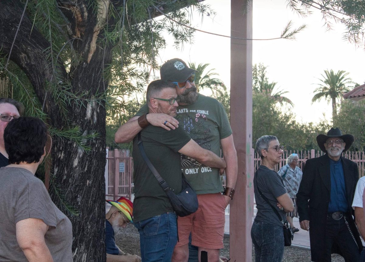 A couple hugs each other during the start of the candlelight ceremony at Catalina Park by 941 N. 4th Avenue, on Sept. 2. The candlelight ceremony was to honor both Vincent Anthony Siqueiros, 42, and Cameron Davis Capara, 33, who were fatally shot at the local gay bar Venture-N.