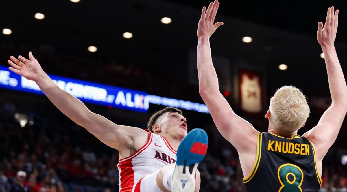 Ivan Kharchenkov falls after contact with a San Francisco player in McKale Center at ALKEME Arena on Oct. 13.