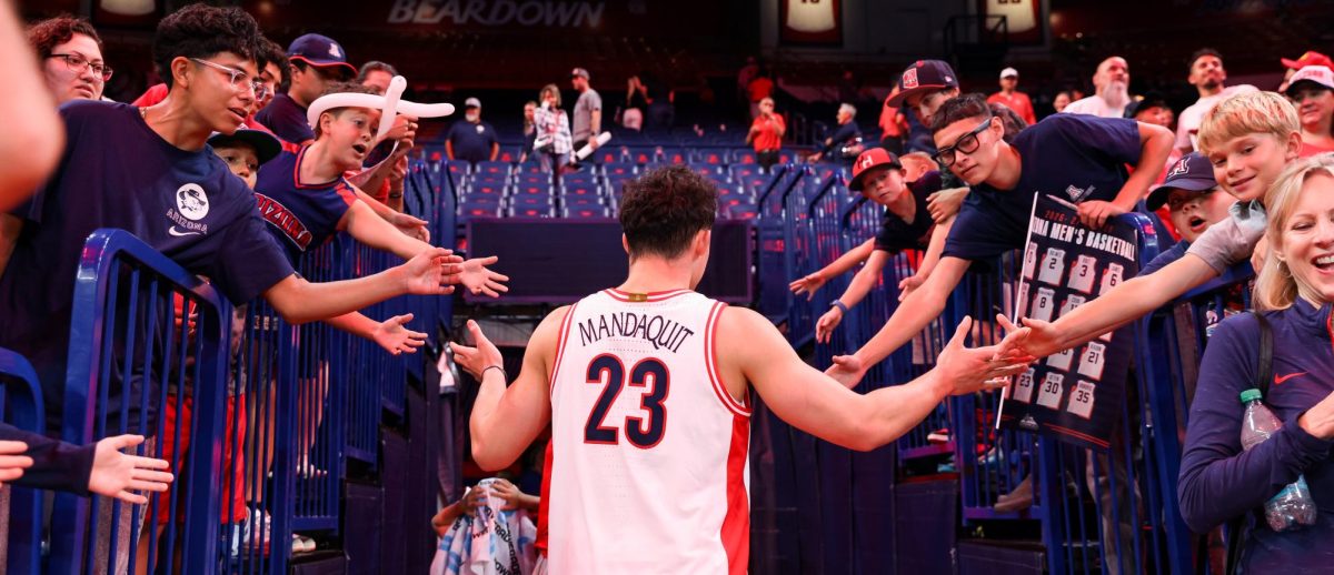 JJ Mandaquit acknowledges fans following a win over San Francisco in McKale Center at ALKEME Arena on Oct. 13.