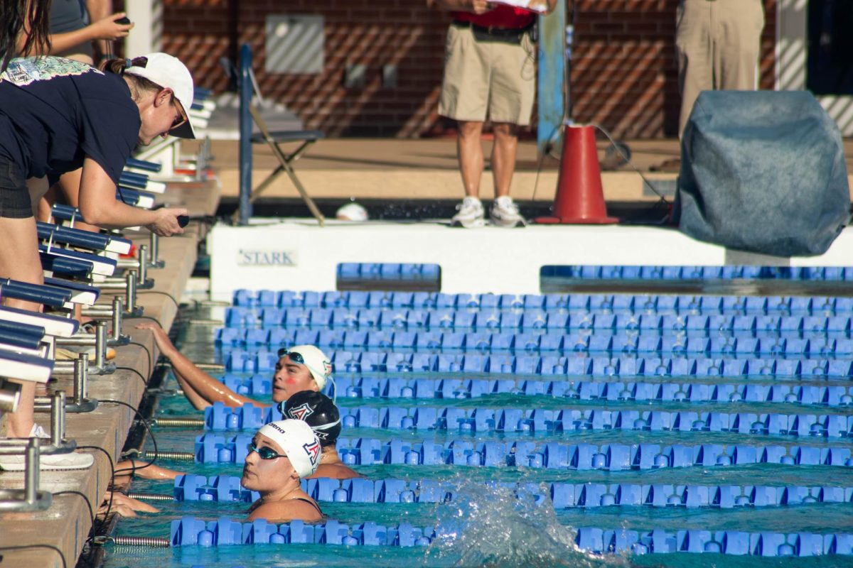 Swimmers check their time after completing the women's 100 butterfly during the Red v. Blue intrasquad meet at the Hillenbrand Aquatic Center on Oct. 2.