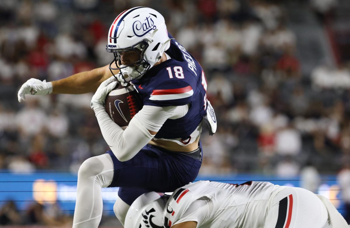 Brandon Phelps vaults over a defenders head to score a touchdown against Cincinnati on Oct. 3 at Casino Del Sol Stadium.
