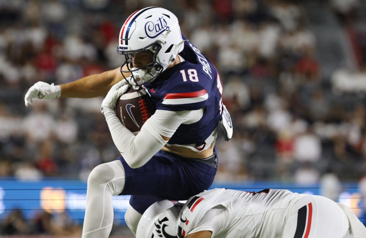 Brandon Phelps vaults over a defenders head to score a touchdown against Cincinnati on Oct. 3 at Casino Del Sol Stadium.