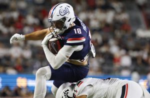 Brandon Phelps vaults over a defenders head to score a touchdown against Cincinnati on Oct. 3 at Casino Del Sol Stadium.